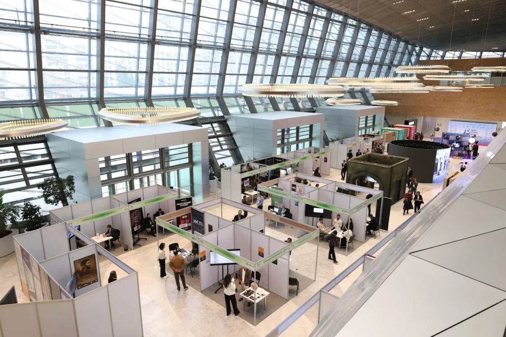 Busy trade show exhibition hall with attendees networking at display stands