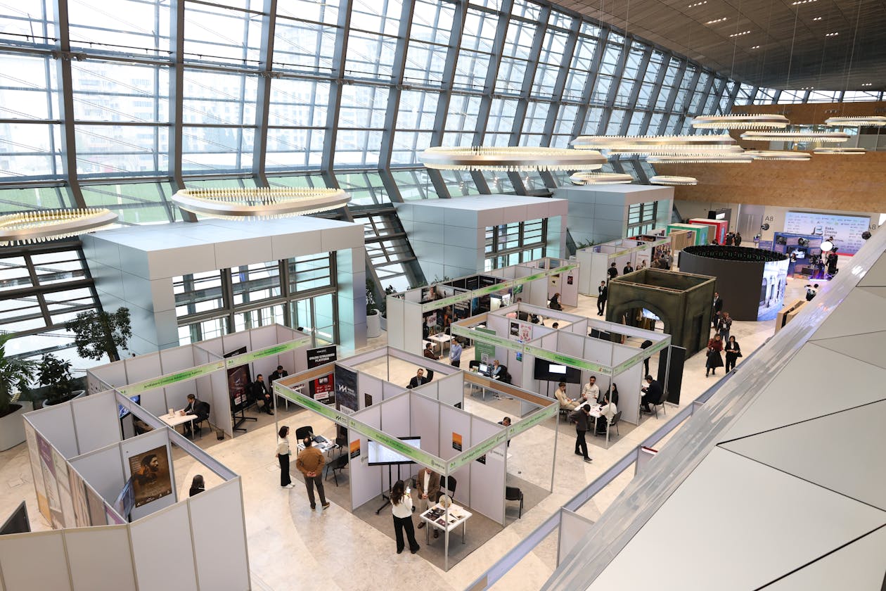 Busy trade show exhibition hall with attendees networking at display stands