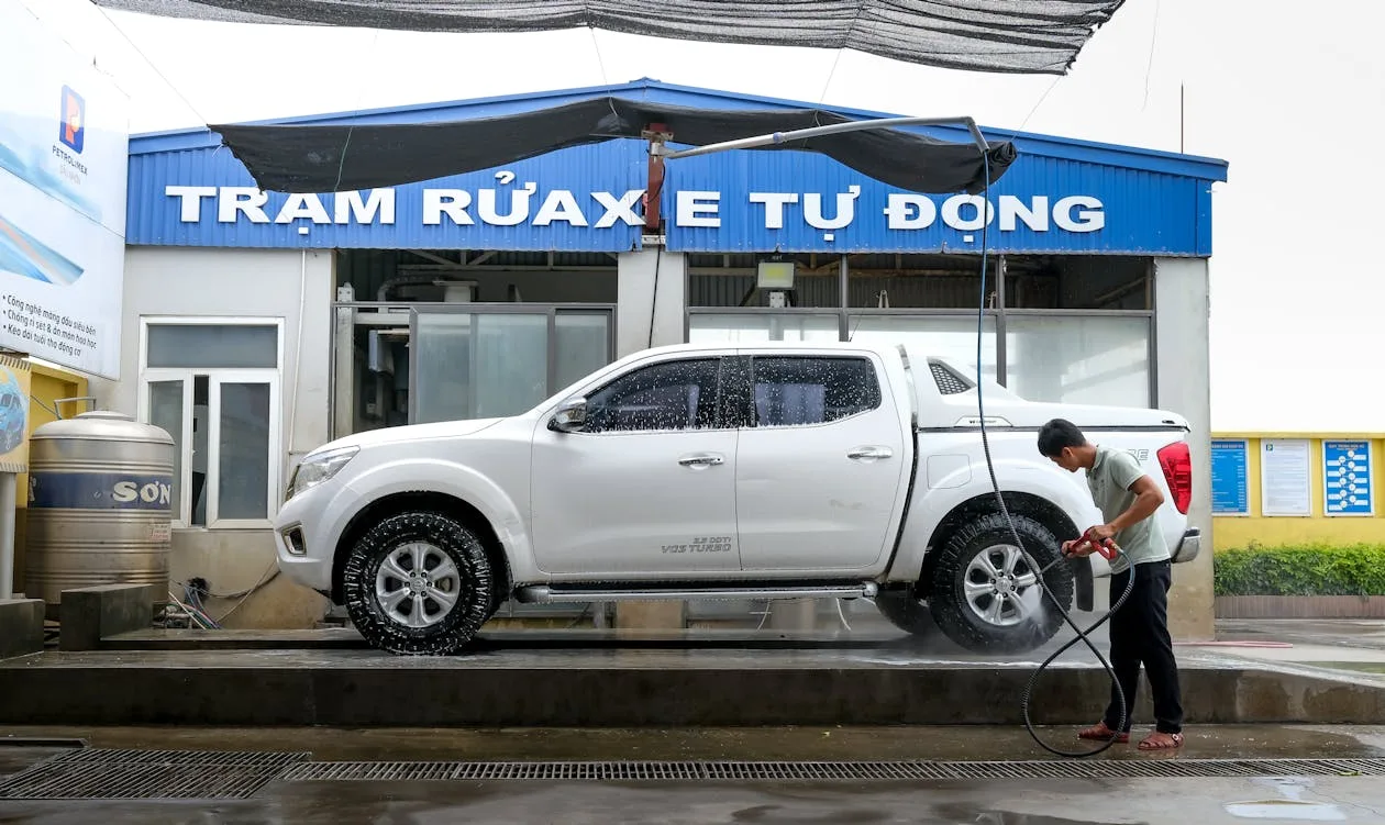 Man hand washing a vehicle to maintain its vinyl wrap
