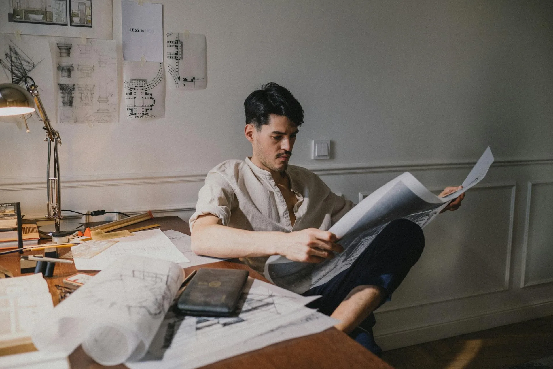 Person reviewing signage design drawings and brief at a desk