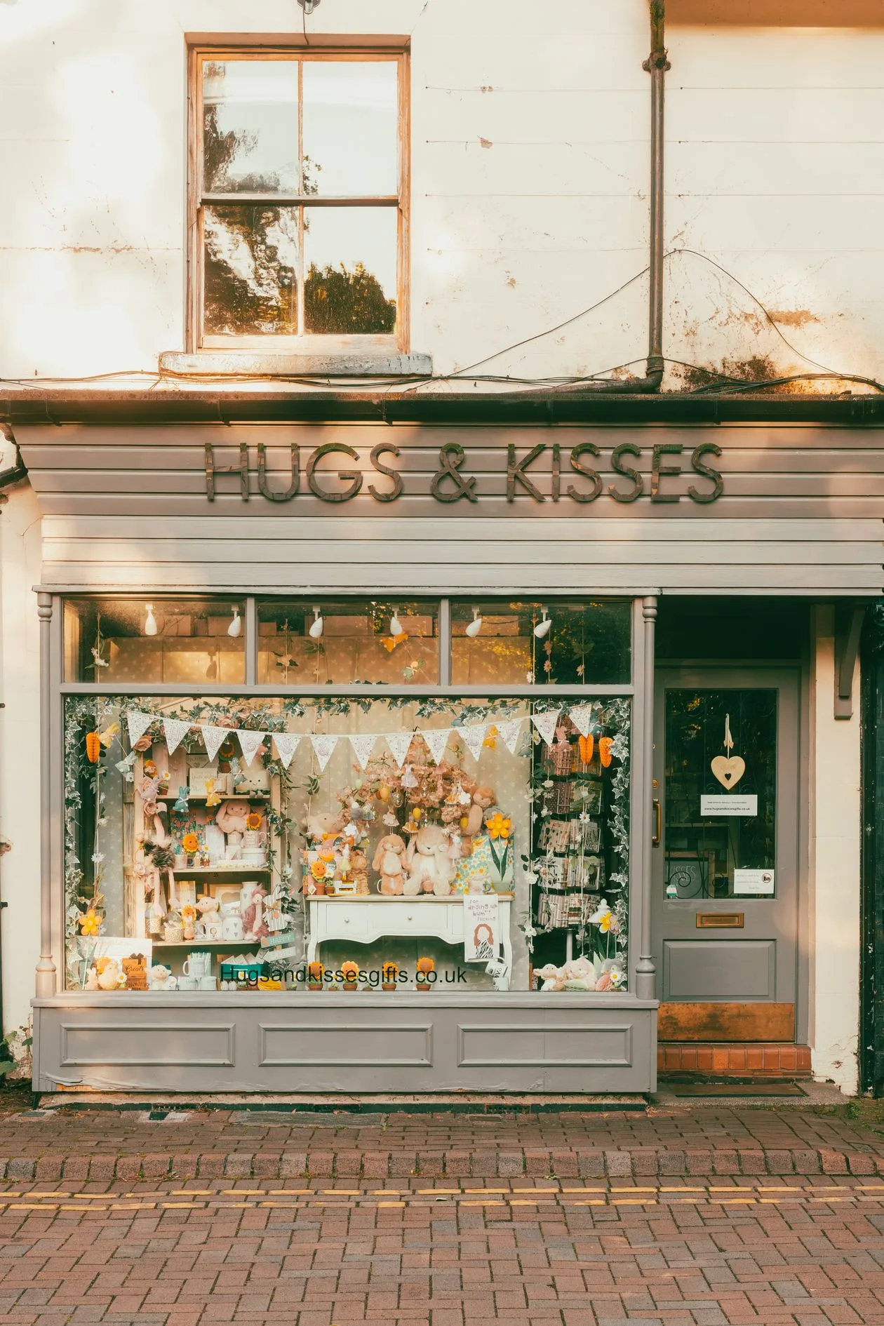 Charming English gift shop exterior with decorated window display and signage