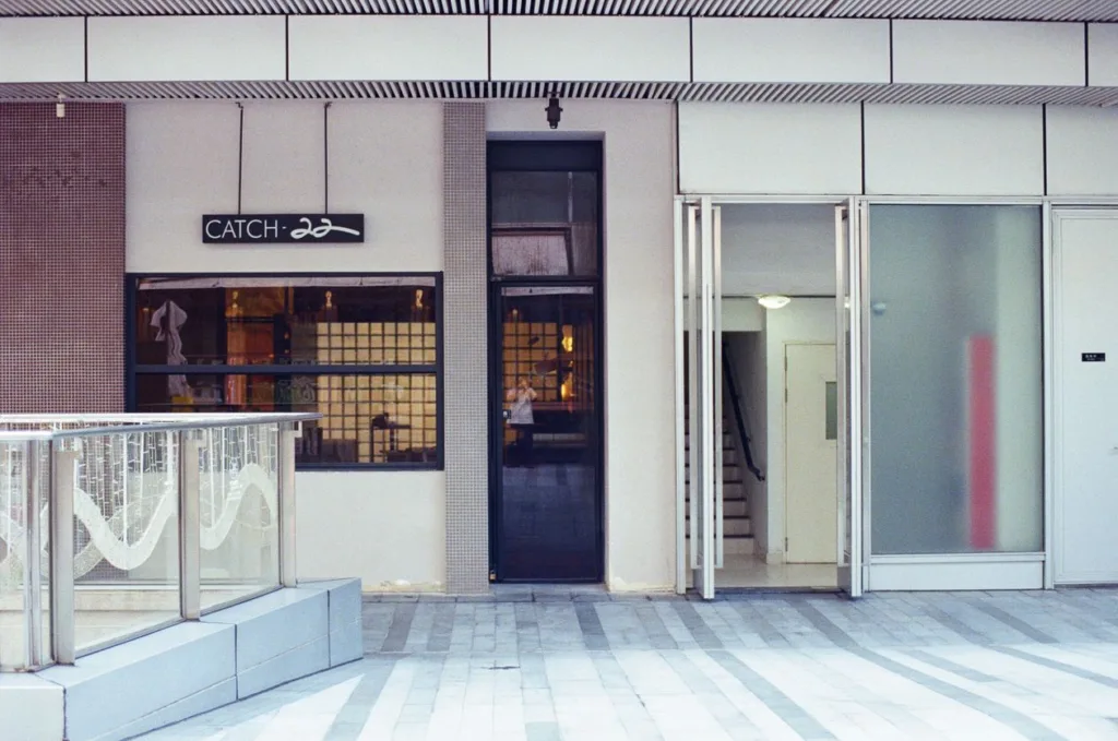 Modern retail storefront with glass doors and clean branded signage on the fascia