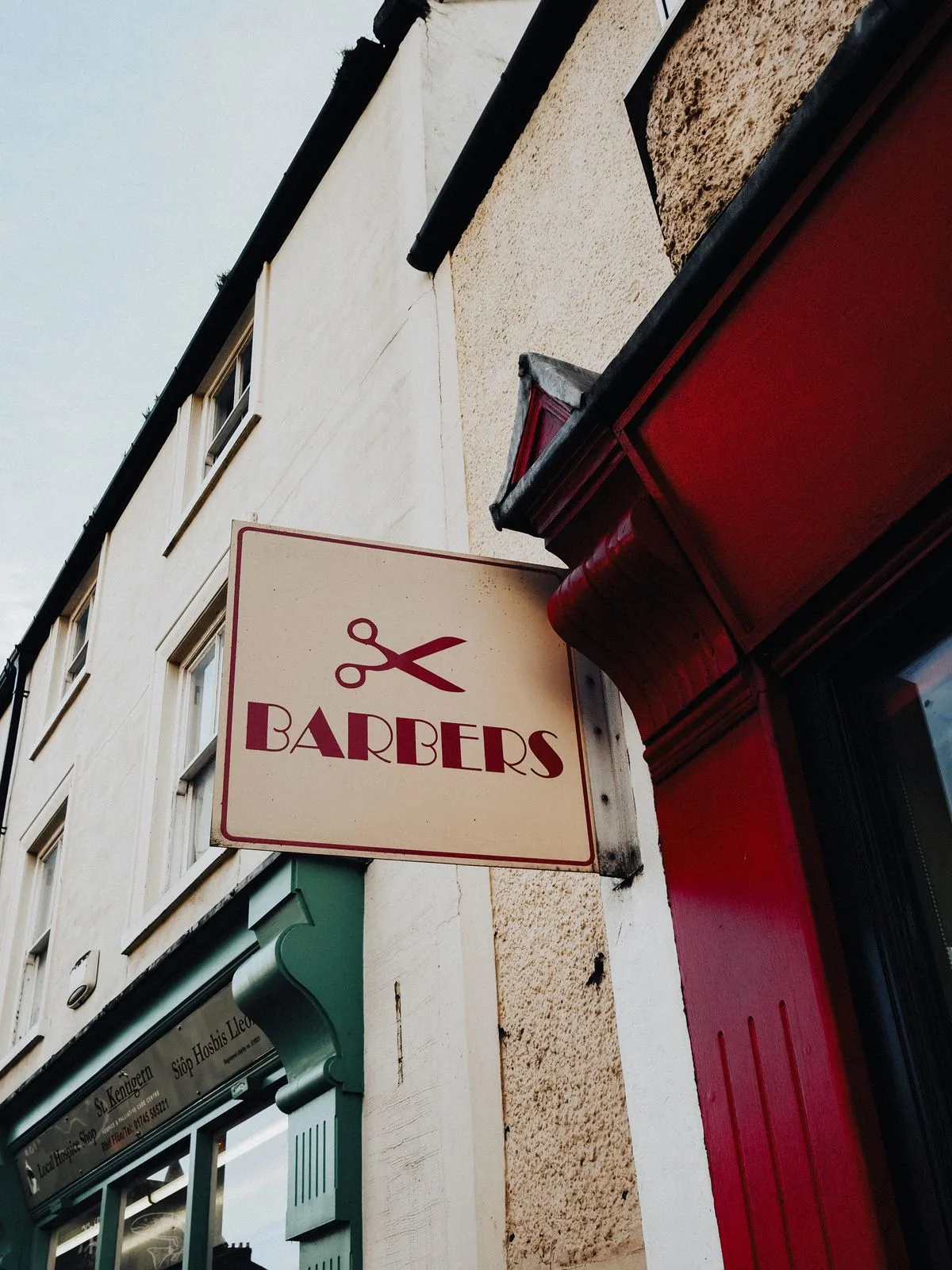 Projecting barbers shop sign with scissors icon