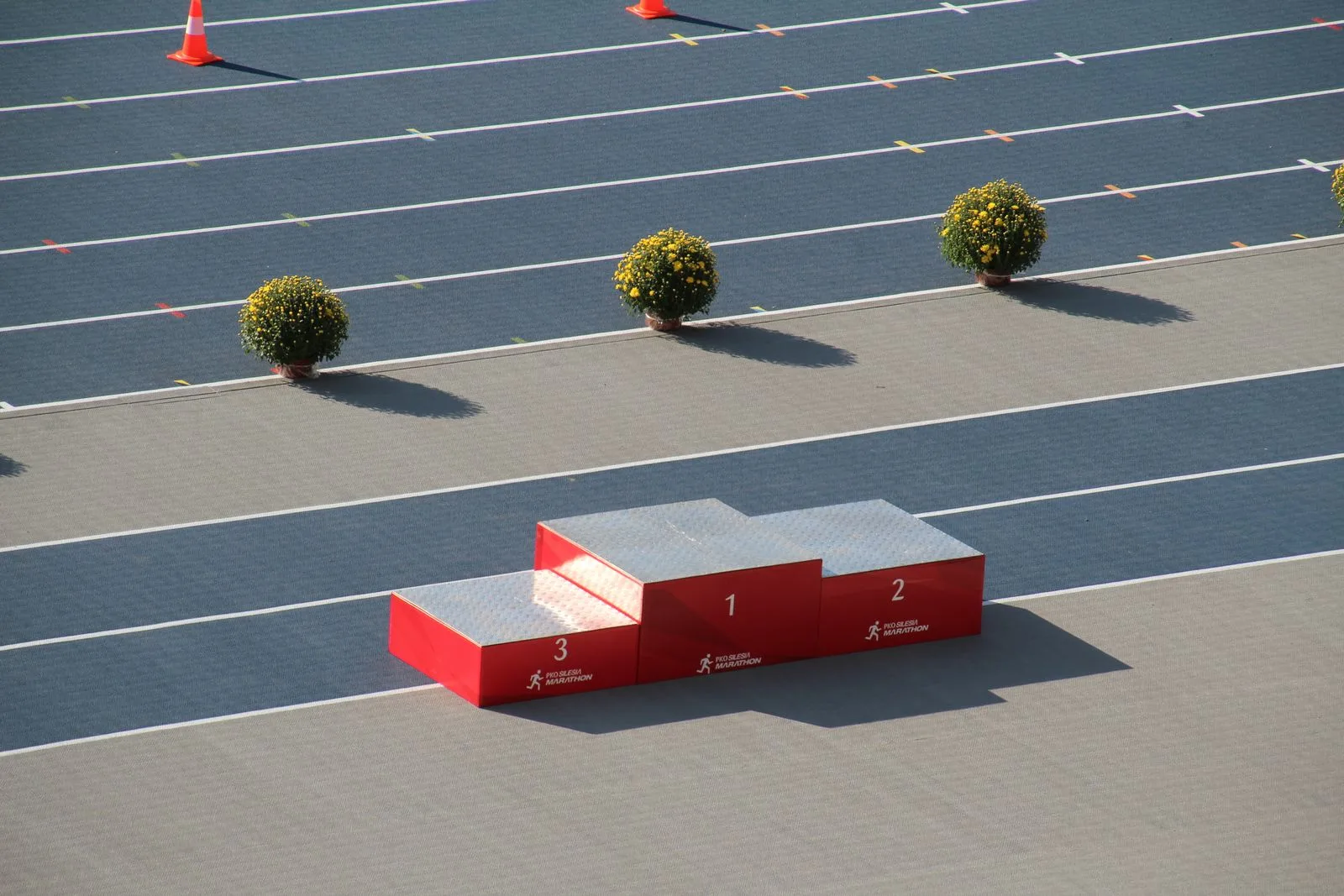 Empty red winner's podium on an outdoor athletics track