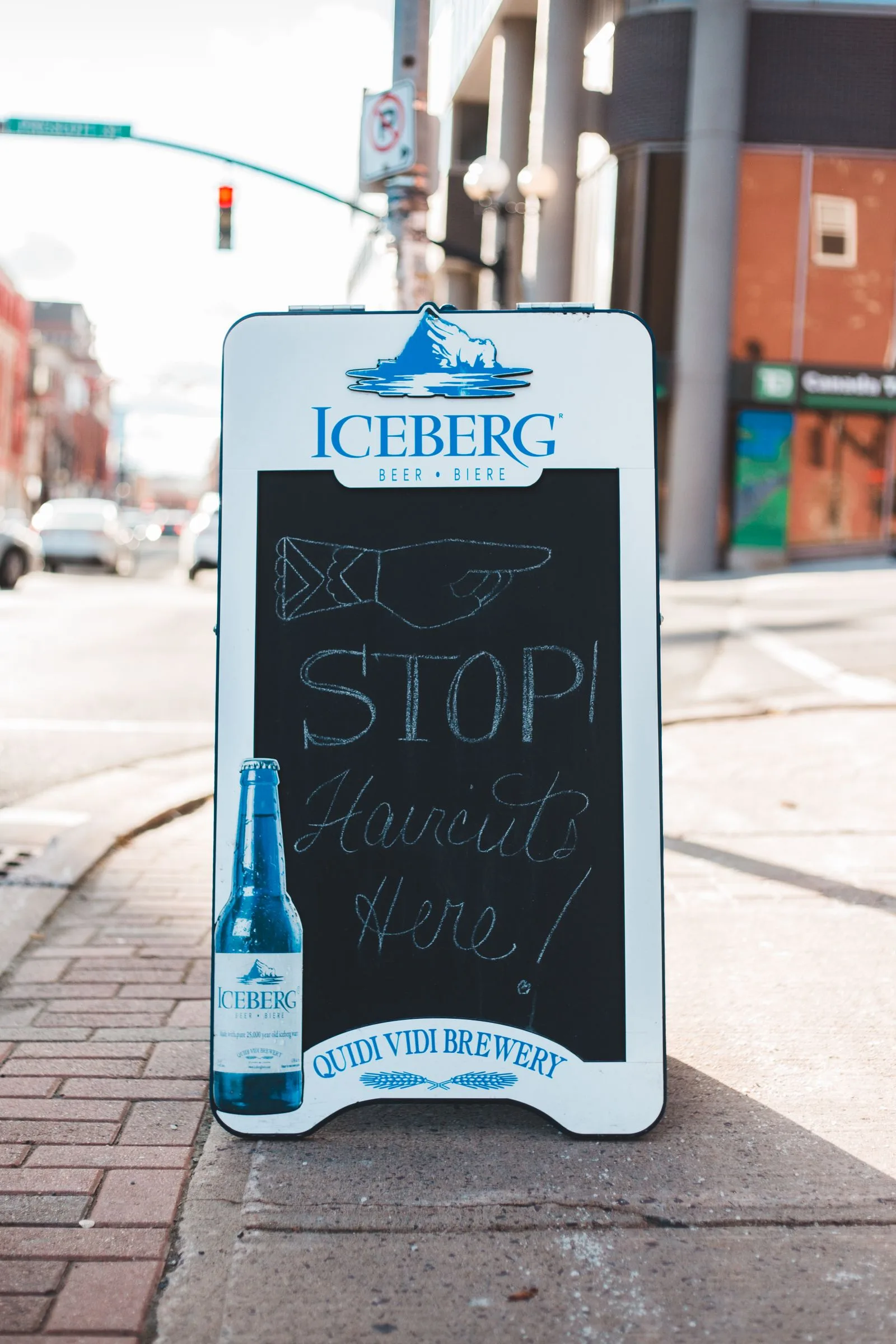 A-board chalkboard sign on a sidewalk outside a shop