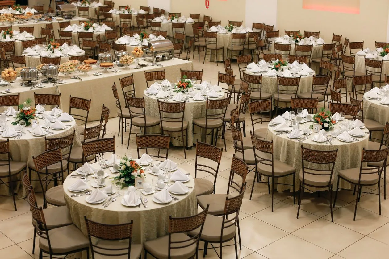 Banquet hall set up with round tables and tablecloths for a fundraising event