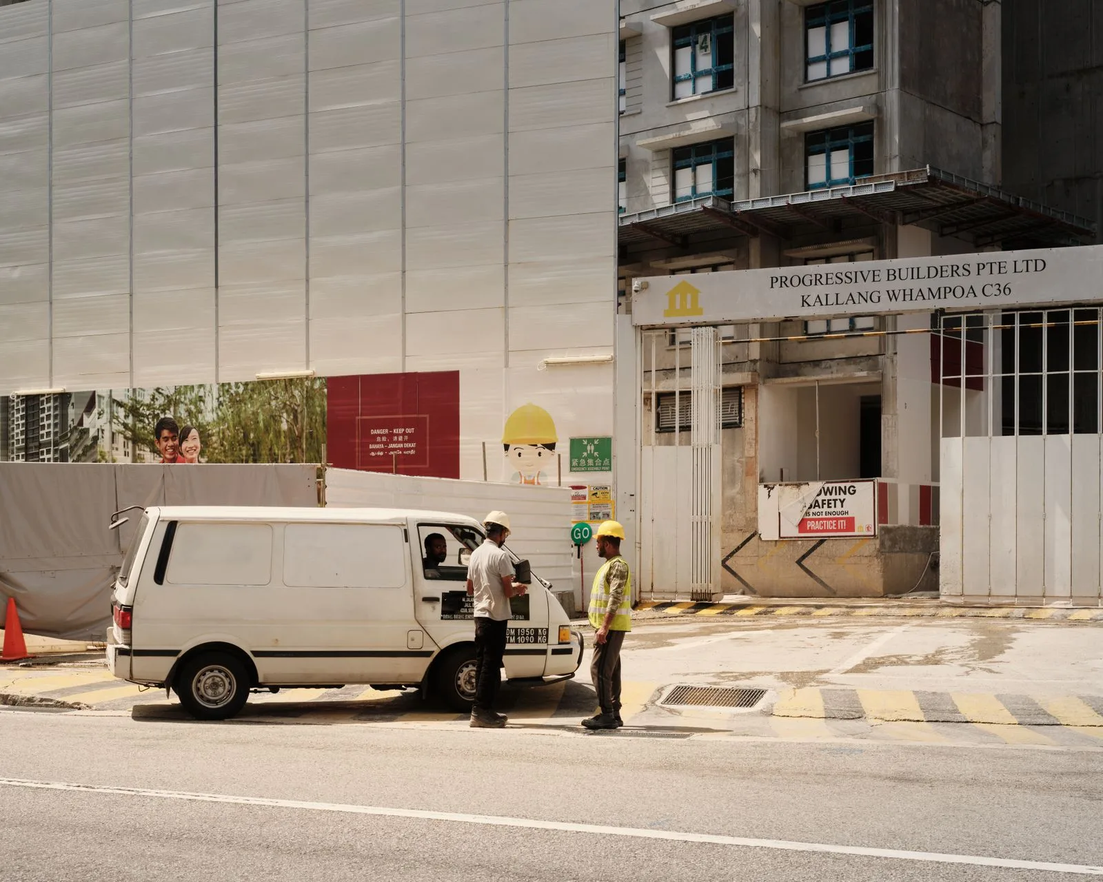 Supply van and workers at an active construction site