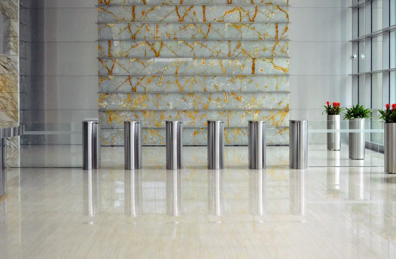 Polished marble entrance lobby with metal bollard dividers