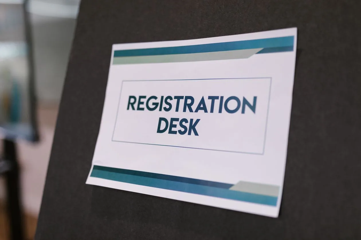 Registration desk sign at a professional event
