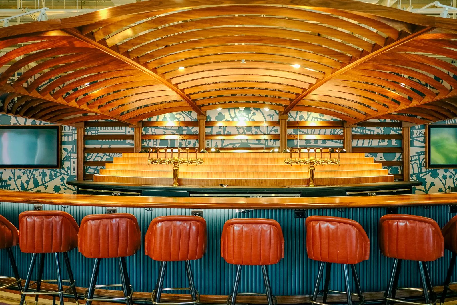 Bar interior with a wooden ceiling and leather stools