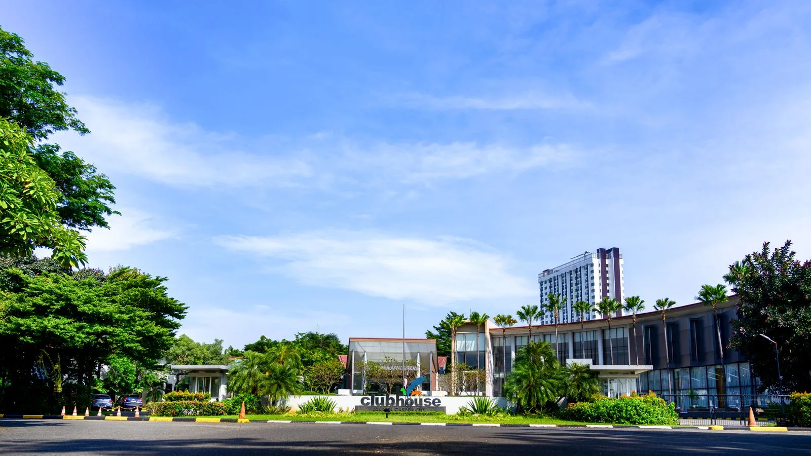 Modern clubhouse building surrounded by greenery