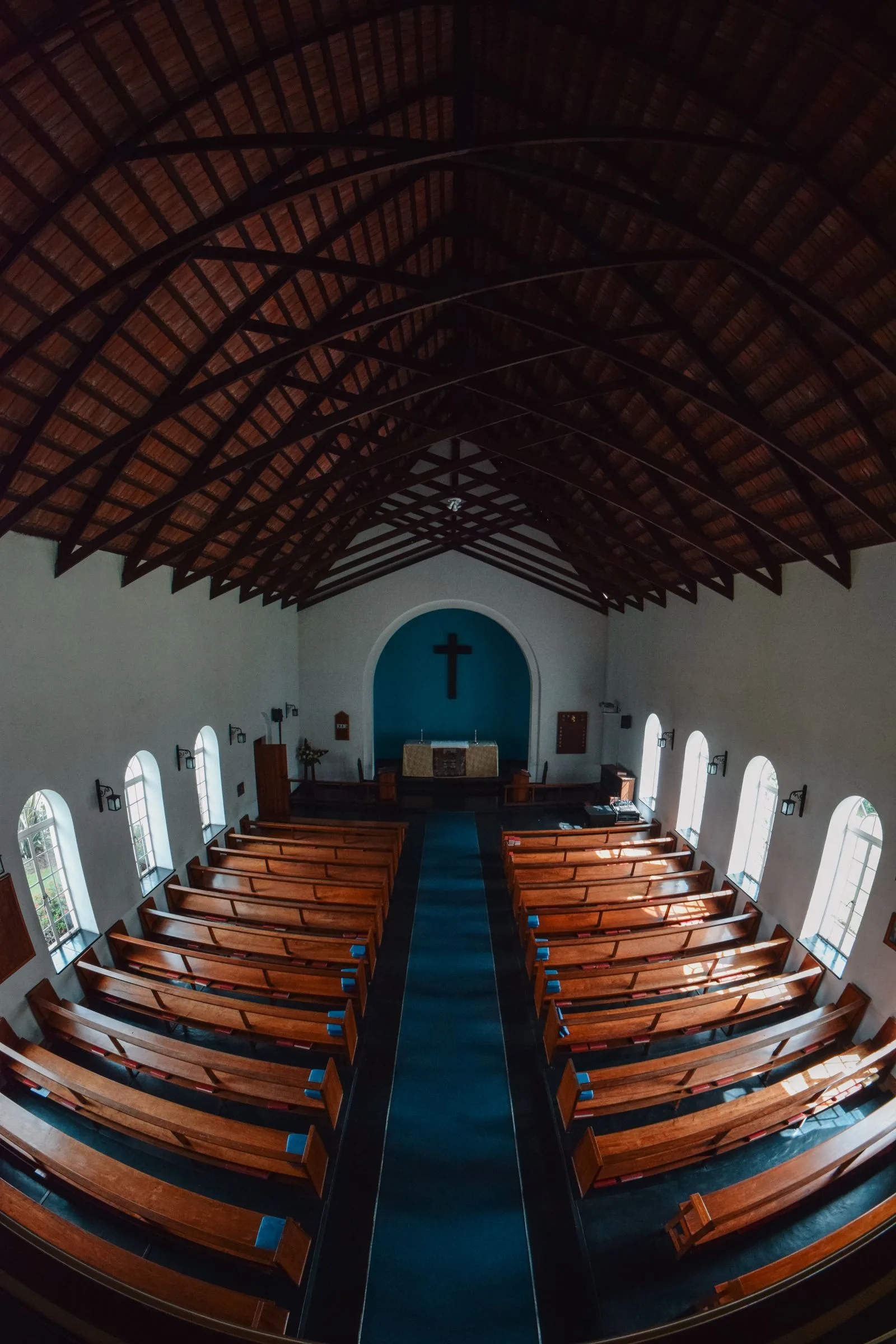 Modest church interior with empty wooden pews