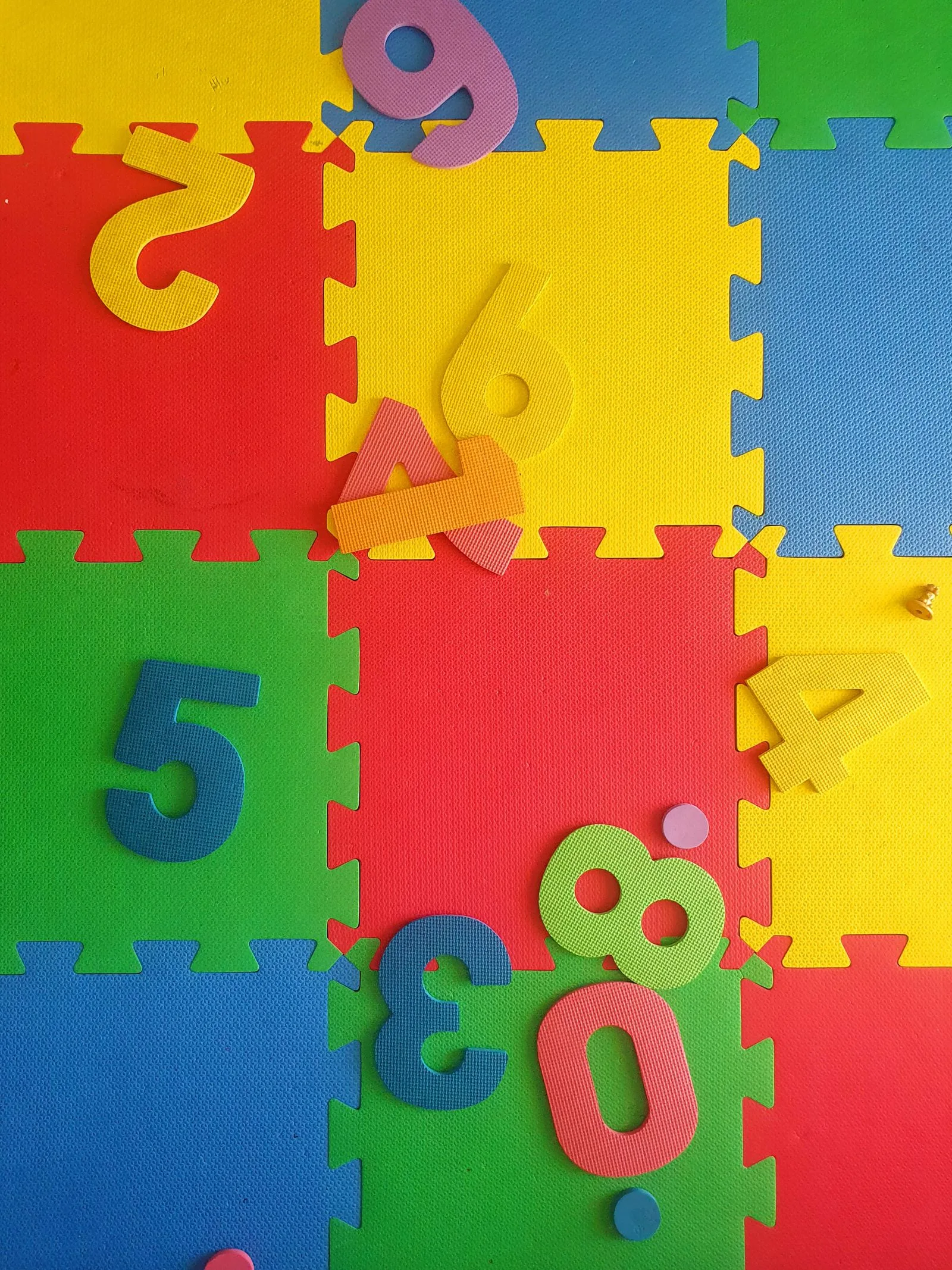 Colourful interlocking foam number mat on a nursery floor