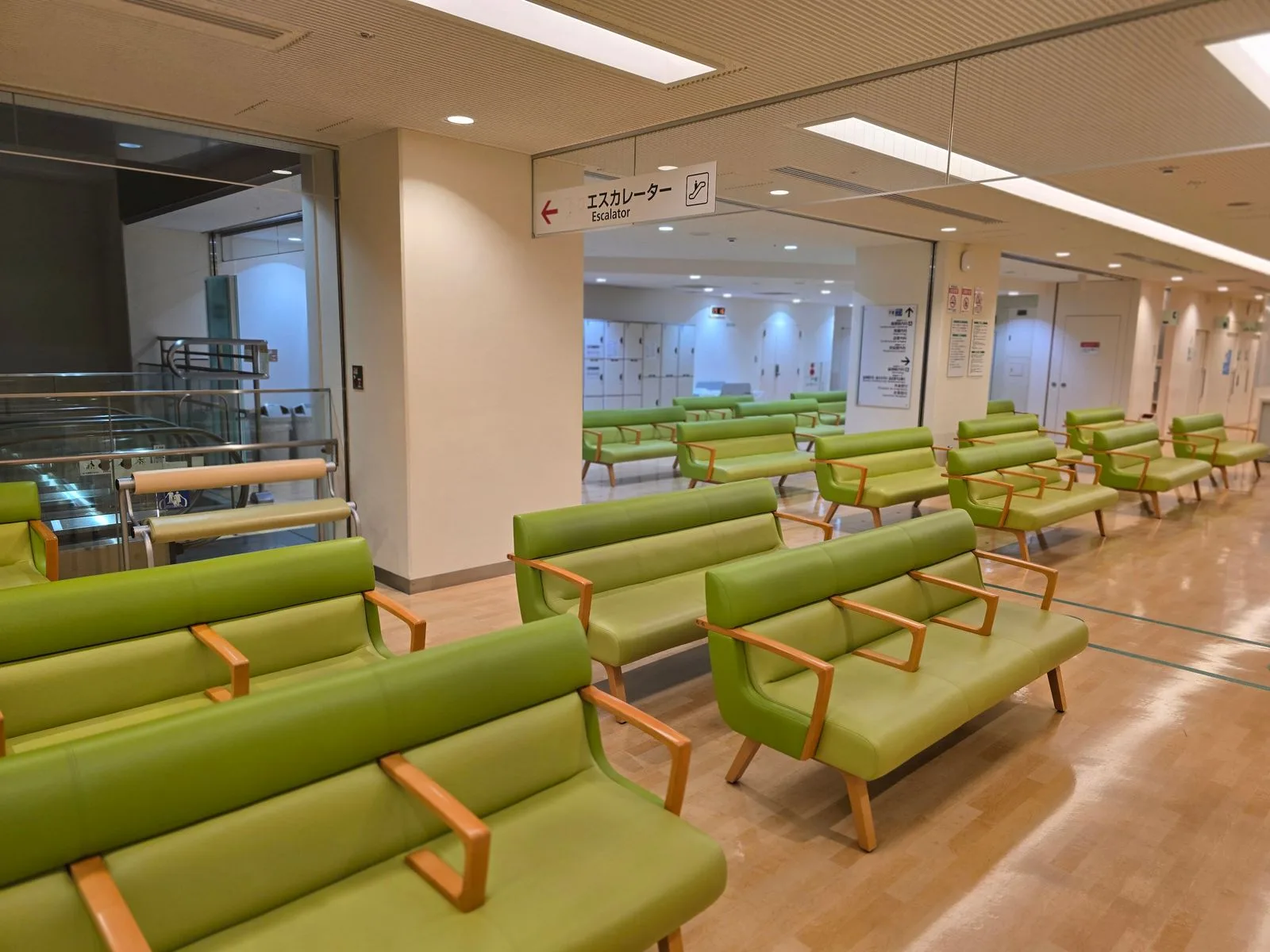 Quiet healthcare waiting area with clear directional wayfinding signage