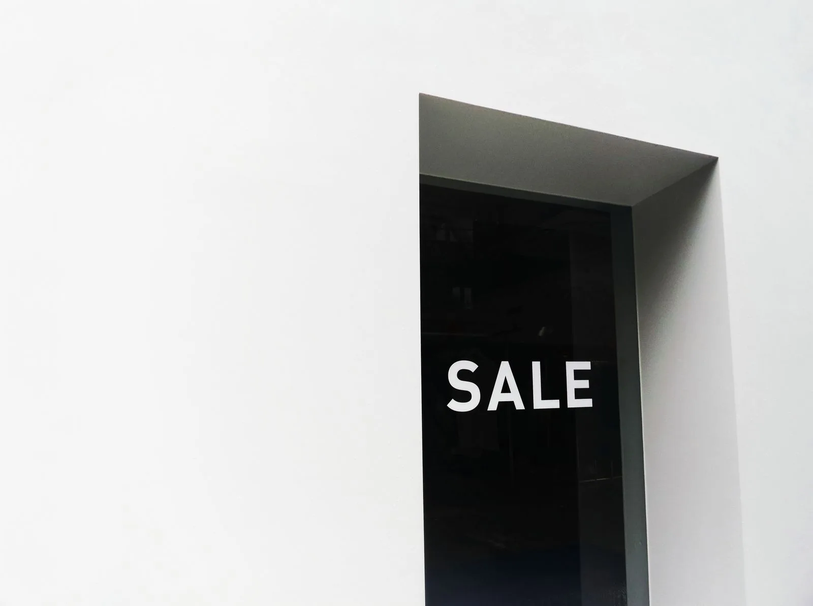 Shop window glass panel with a sale sign