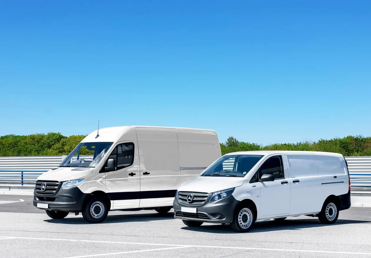 Two plain white commercial vans parked side by side, ready for branding