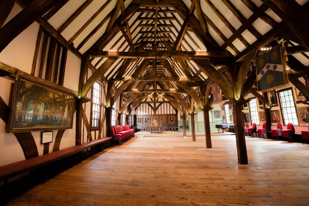Grand timber-framed hall interior with rows of chairs